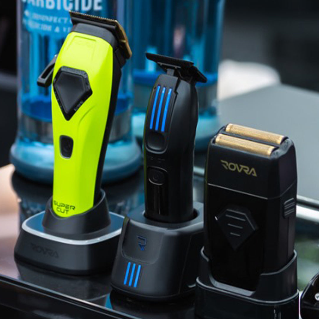 High speed barber shaver 8800 RPM in yellow and black with charging stands on reflective surface